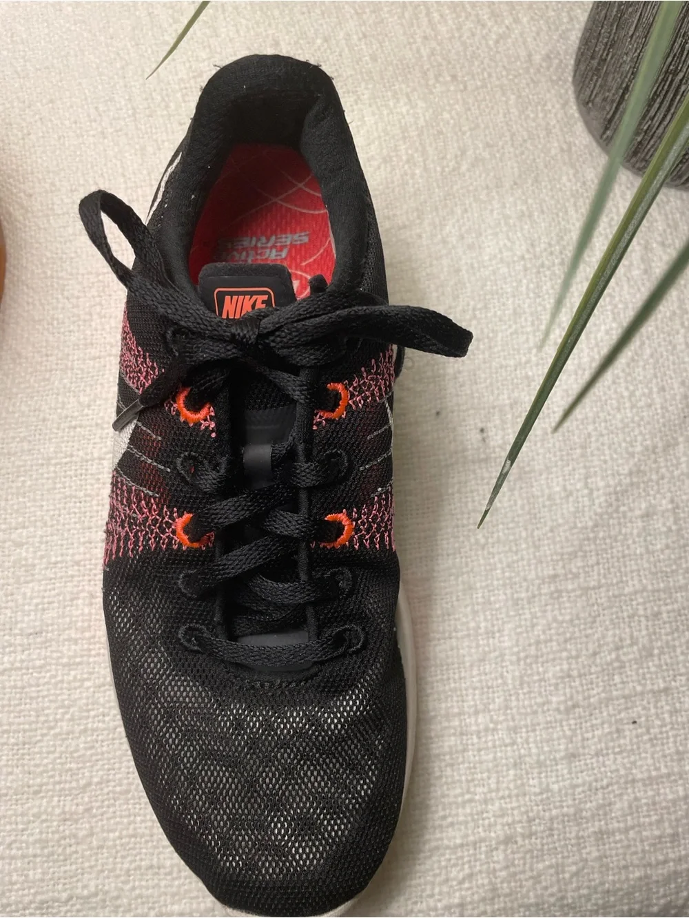 Nike Women’s Black and Coral Knit Running Shoe